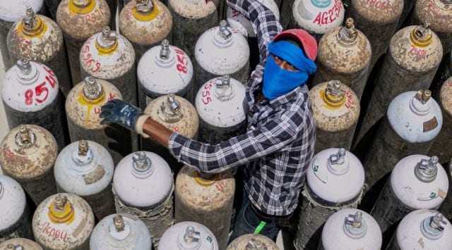 A worker sorts oxygen cylinders to be used for Covid-19 patients, at Jawaharlal Nehru Hospital in Ajmer, Friday, April 23, 2021. (PTI Photo)
