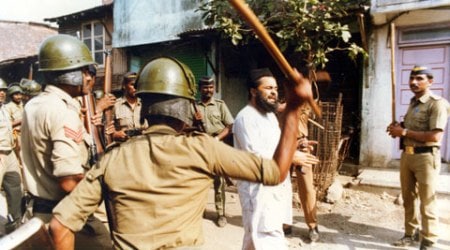Police Personnels beat a muslim man during the Mumbai riots of 93 at Gowandi. (Source: Express Photo by Mukesh Parpiani)