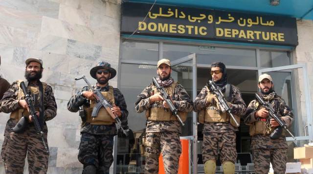 Taliban forces stand guard at the airport in Kabul on Tuesday; (left) Major General Chris Donahue, the last US service member to leave Kabul airport on Monday night. (Reuters)