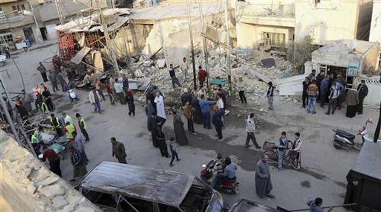Civilians inspect the site of Friday's car bomb in Baghdad's Gorayaat neighborhood, Iraq (Source: AP File Photo)