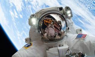 NASA astronaut takes selfie from space with Earth behind him