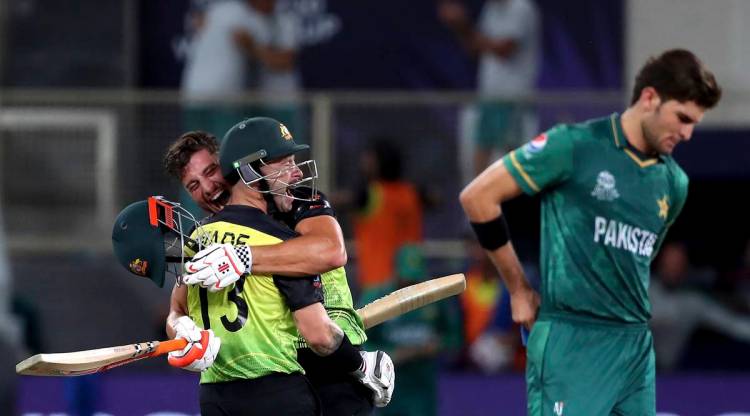 Pakistan's Shaheen Afridi, right, reacts as Australia's Matthew Wade, left, and Marcus Stoinis celebrate their win during the Cricket Twenty20 World Cup semi-final match between Pakistan and Australia in Dubai, UAE, Thursday, Nov. 11, 2021. (AP Photo/Aijaz Rahi)