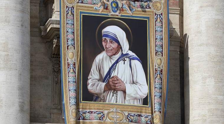 FILE - In this Thursday, Sept. 1, 2016 file photo, a tapestry showing Mother Teresa hangs from the central balcony of St. Peter's Basilica, in St. Peter's Square, at the Vatican. For many of the poor and destitute whom Mother Teresa served, the tiny nun was a living saint. Many at the Vatican would agree, but the Catholic Church nevertheless has a grueling process to make it official, involving volumes of historical research, the hunt for miracles and teams of experts to weigh the evidence. (AP Photo/Alessandra Tarantino, File)