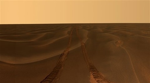 This image provided by NASA, shows rover tracks disappearing toward the horizon in a sea of sand between the craters Endurance and Victoria on the Meridiani Plains. 