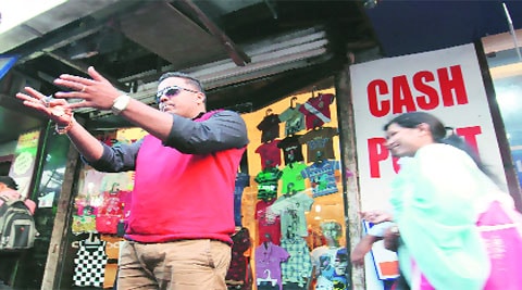 Mayur Kokam points at the foreign exchange shop near Leopold Cafe where five women attempted to break-in on January 4. Vasant Prabhu