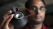 Graduate student Apoorva Kiran holds a 3-D printed, fully functional loudspeaker. (Cornell University)