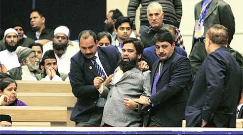 Seelampur activist Fahim Baig being restrained by security personnel at the Vigyan Bhavan auditorium on Wednesday.
