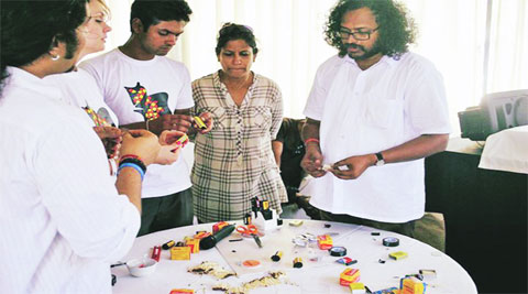 Participants during a session on pinhole photography; an attendee working on a line following bot at a workshop