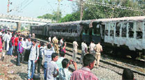 The burnt coaches of Bandra-Dehradun Express parked at Dahanu Road station, in Thane district, on Wednesday. 	Deepak Joshi