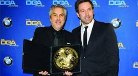 Actor and director Ben Affleck (R) presents Mexican director Alfonso Cuaron with the Feature Film award for Gravity' during the 66th annual Directors Guild of America Awards in Beverly Hills, California January 25, 2014