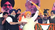 BJP’s PM candidate Narendra Modi being honoured by Punjab Dy CM Sukhbir Badal, while Rajnath Singh and Parkash Singh Badal look on during the Fateh Rally in Ludhiana on Sunday. 	Gurmeet Singh