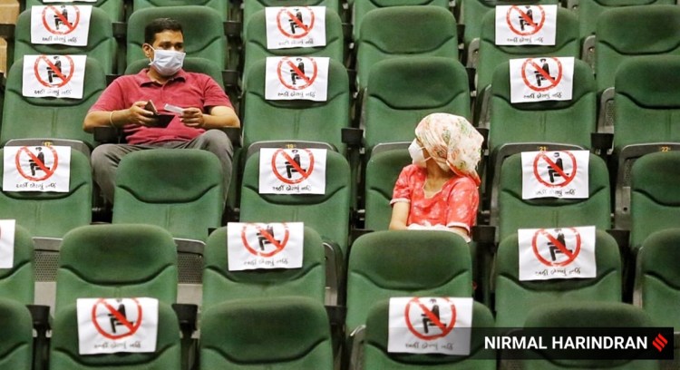 Beneficiaries of Covid-19 vaccine wait at the observation area after receiving their jabs at Tagore Hall in Ahmedabad.
(Express photo by Nirmal Harindran)