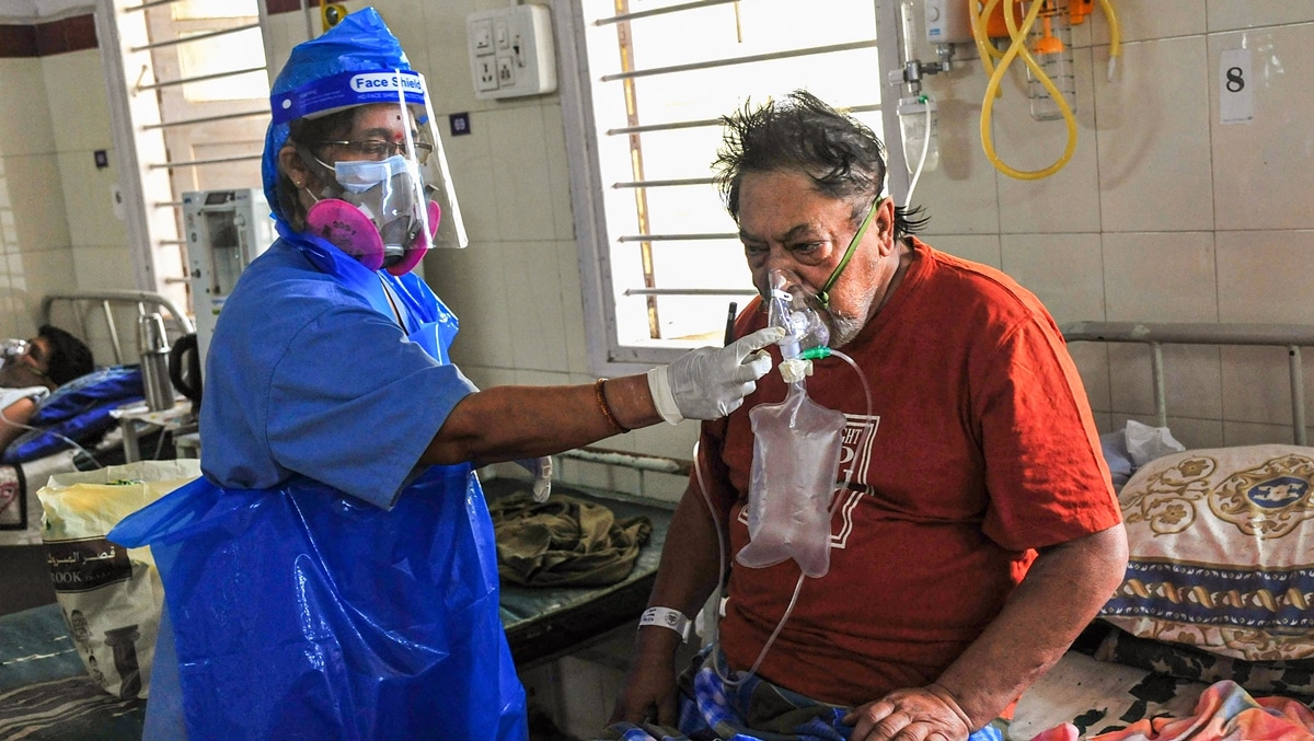 Bengaluru: A health worker checks a COVID-19 patient on oxygen support at a hospital, during the second wave of the coronavirus pandemic in Bengaluru. (PTI Photo)