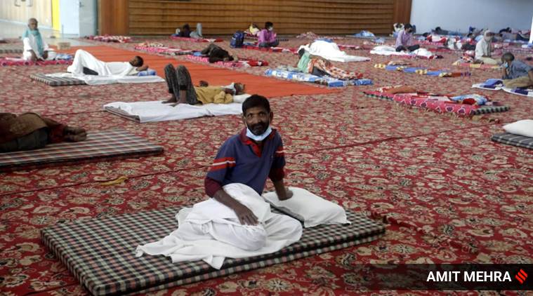 At the Yamuna Sports Complex auditorium in Delhi, Friday. It houses the homeless and migrants stopped by police. (Photo: Amit Mehra)