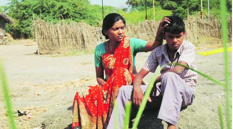 Usha Jadhav and Hansaraj Jagtap before their house and crematorium