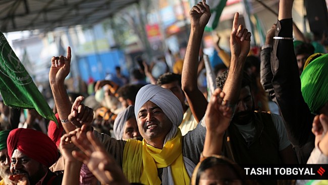 Protesting farmers celebrate following the announcement of suspension of their year-long agitation against farm laws. (Express Photo by Tashi Tobgyal)