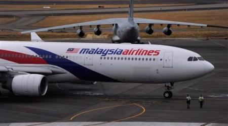 In this file photo, a Malaysia Airlines plane, foreground, prepares to go out onto the runway in Perth. (AP)