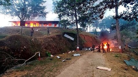 Assam Rifles personnel stand near their burning camp after some miscreants put it on fire over the death of 13 civilians, who were allegedly killed by Armed Forces, in Mon district, Sunday, Dec. 5, 2021. (PTI Photo)