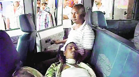 An injured policeman being taken to hospital, Tuesday. 