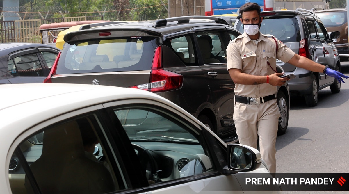Delhi police with Civil Defence volunteer jointly issuing Covid challans to those who are not wearing mask properly at Ghazipur earlier this year. (Express photo by Prem Nath Pandey)
