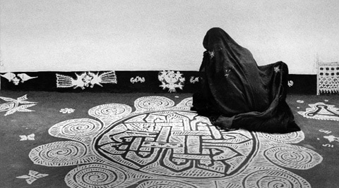 A woman drawing a mandana design, Rajasthan, 1980.