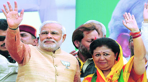 Narendra Modi supporters at his rally in Solan (HP); (right) with Mala Rajya Laxmi Shah in Dehradun, Tuesday.