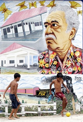  In this Jan. 4, 2006 file photo, boys play soccer in front a mural of Colombian Nobel laureate Gabriel Garcia Marquez in Aracataca, Colombia, the writer's hometown. 