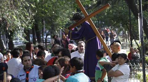 People who were participating in a Holy Week procession stop after a strong earthquake jolted Mexico City, Friday, April 18, 2014.