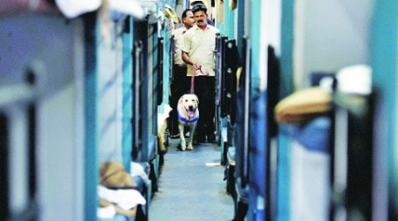 A bomb disposal squad scans the Bangalore-Guwahati Superfast Express following the blasts on Thursday.