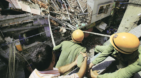 Fire-fighters at the site of the building collapse in Sadar Bazar on Sunday. (Source: Express photo by Ravi Kanojia)