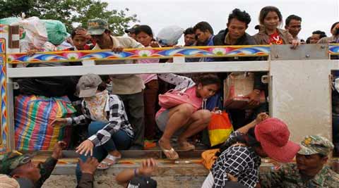 Cambodian migrant workers get off a Thai truck upon their arrival from Thailand at a Cambodia-Thailand's international border gate in Poipet, Cambodia. (Source: AP)
