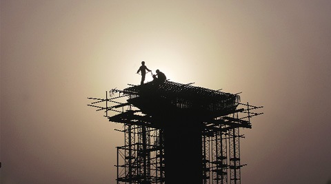 Metro workers at a site near Mayur Vihar Phase-1 on Monday. (Source: Exp[ress photo by Oinam Anand)