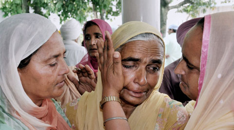 Amritsar: A relative is consoled during a prayer meeting for the Indian workers stranded in Iraq, at Baba Budha Ji Sahib Gurdwara at Kathunangal in Amritsar on Tuesday. (Source: PTI)