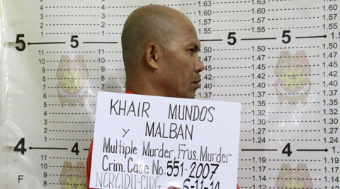 Khair Mundos, a top commander of the Abu Sayyaf extremist group who is on the U.S. list of most-wanted terrorists and has acknowledged receiving al-Qaida funds to finance bombings in the country, undergoes a police booking procedure following his capture near Manila's international airport. (AP)