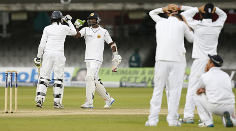 Sri Lanka's Nuwan Pradeep (L) and teammate Shaminda Eranga touch fists after guiding the match to a draw on the fifth day of the first Test in London. (Source: AP)  