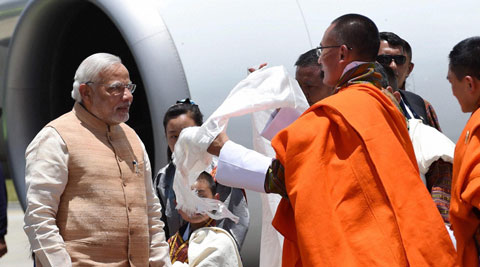 Prime Minister Narendra Modi being received by his Bhutanese counterpart Tshering Tobgay on his arrival at the Paro International Airport in Bhutan on Sunday. (Source: PTI)