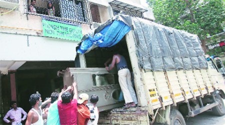 Packers and movers at work in Campa Cola compound.