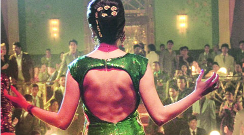 Anushka Sharma in a green and gold sequined gown in applique flames