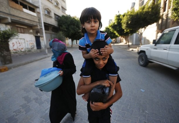 PHOTOS: Gaza crisis: Israel warns of more airstrikes; Palestinians flee ...