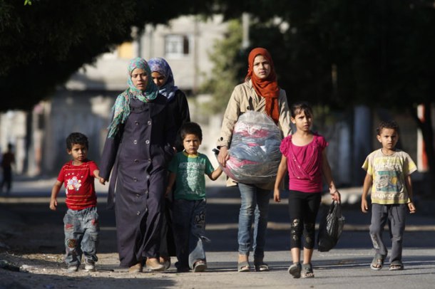 PHOTOS: Gaza crisis: Israel warns of more airstrikes; Palestinians flee ...