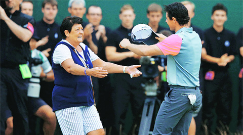 McIlroy greets his emotional mother as he left the 18th green a three-time major champion.  Source:Reuters