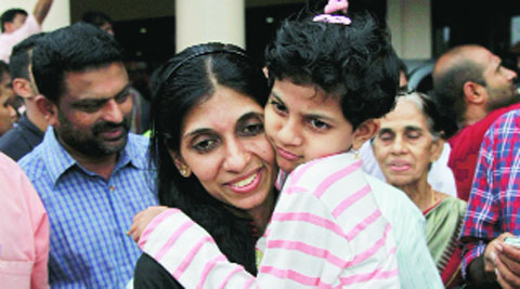 Indian nurse Merina Jose with her daughter after returning from Iraq, in Kochi on Saturday. (Reuters)