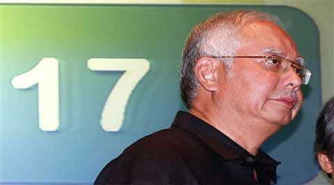 Malaysian PM Najib Razak, walks away after a media conference at a hotel in Kuala Lumpur International Airport