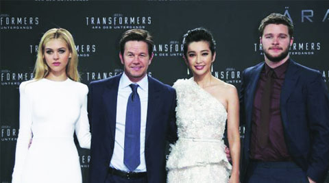 (L-R) Cast members Nicola Peltz, Mark Wahlberg, Li Bingbing and Jack Reynor pose for pictures before the European premiere of the movie Transformers: Age of Extinction in Berlin