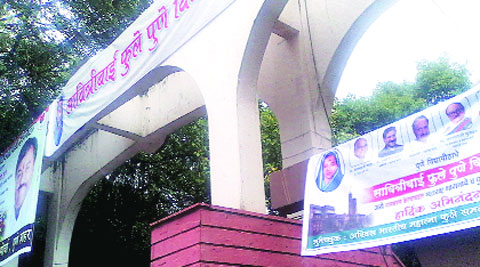 Banners of political parties claim credit for renaming of the university.