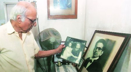Professor Sumit Mukherjee shows a portrait of Dr Subhas Mukherjee and his wife Namita at thier Southern Avenue apartment in South Kolkata. Prof Sumit was an assistant of Dr Subhas. (Express Photo:Partha Paul)