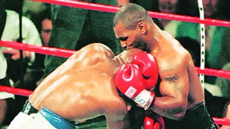 Mike Tyson bites Holyfield’s ear during a match in 1997