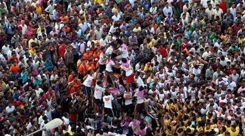 Young boys trying to form a human pyramid to reach and break a clay pot containing curd during the celebrations. (Source: Express photo by Pradip Das)
