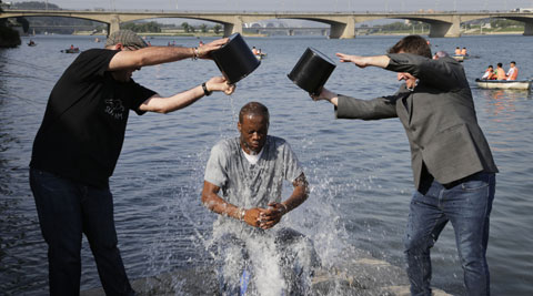 Two-time Grammy award winning rapper and a founding member of the Fugees, Pras Michel, gets doused by his friends for the ALS Ice Bucket Challenge, Sunday, Aug. 31, 2014 in Pyongyang, North Korea. (Source: AP)