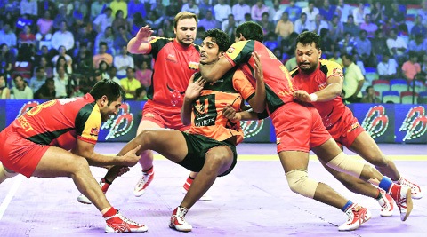 U Mumba player being caught by Bengaluru Bulls players during their  Pro-Kabaddi match in New Delhi. (Source: PTI)